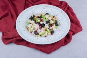 Vegetable salad with black olives and pomegranate seeds