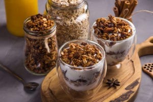 Dessert with granola and yogurt in glasses with double glass for breakfast
