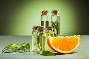 The oranges oil from orange on green studio background