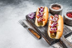 vegetarian-hot-dog-with-with-toppings-meatless-sausage-white-background-top-view-copy-space