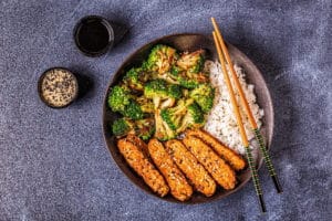 Fried tempeh with rice and broccoli, traditional indonesian cuisine