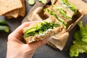 woman-cook-traditional-english-tea-cucumber-sandwiches-with-ricotta-dill-breakfast_91908-7634