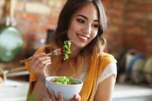 beautiful-young-woman-eating-healthy-salad